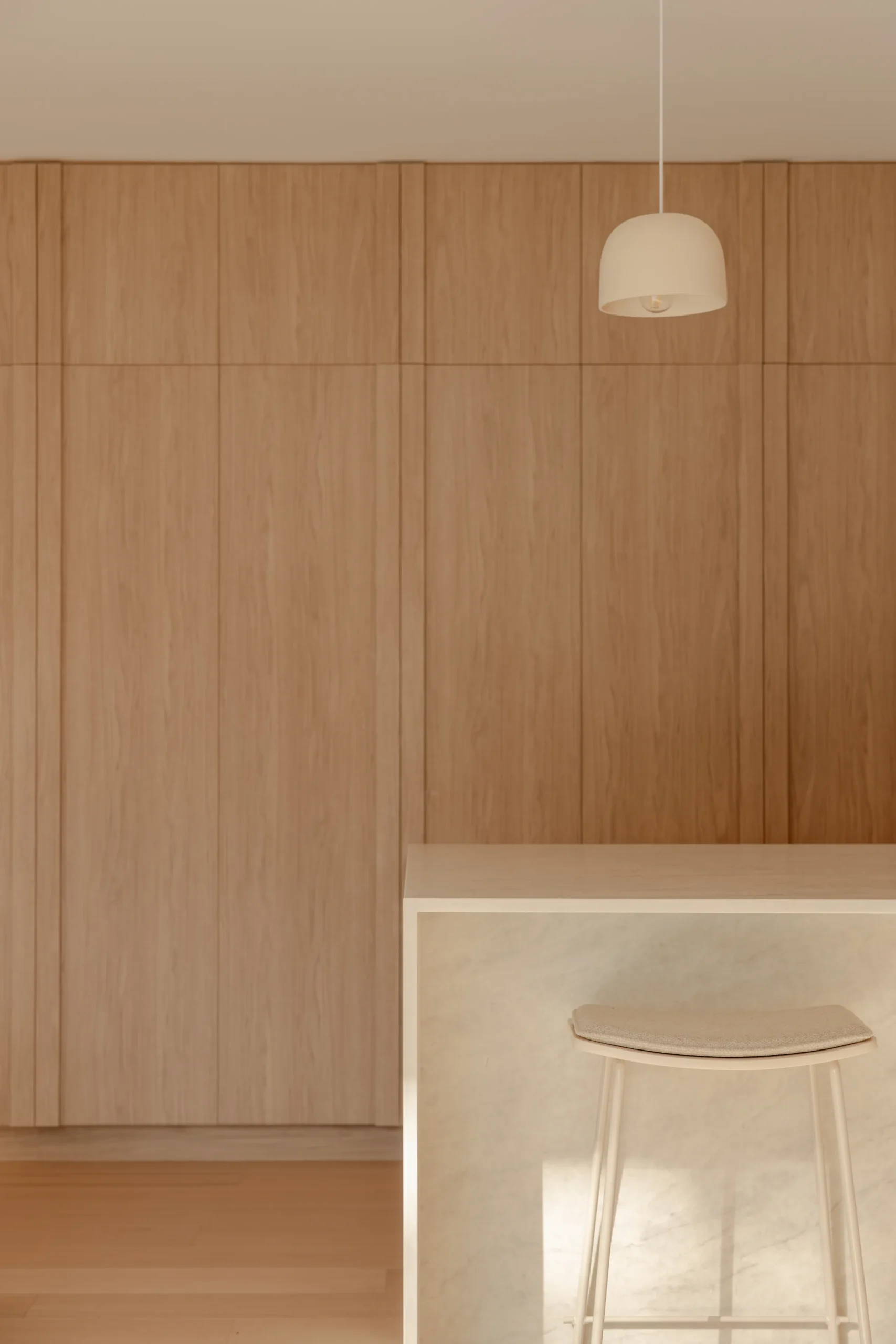 Timber-panelled kitchen wall with pendant light above a stone breakfast bar and stool