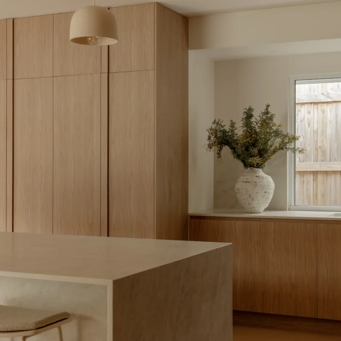 Kitchen corner with pendant light and vase in a window nook