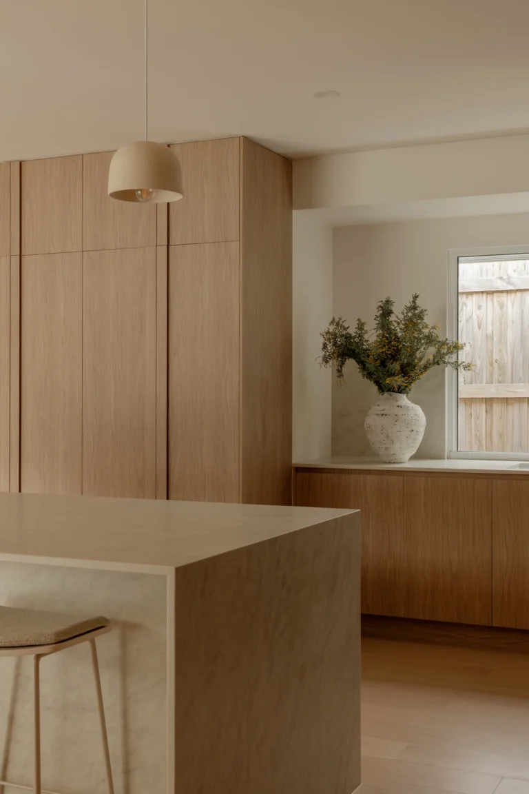 Kitchen corner with pendant light and vase in a window nook